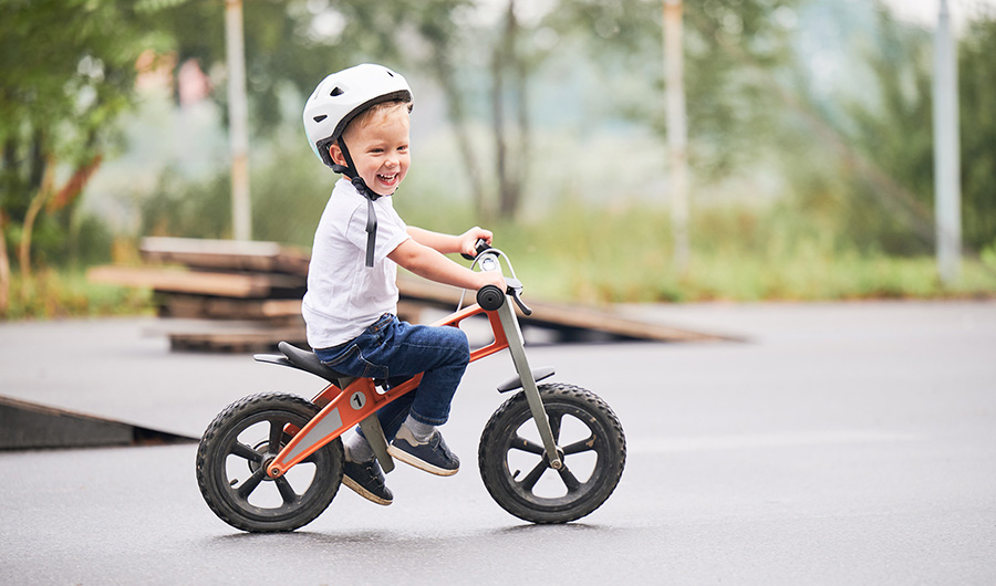 kid riding his bike and smiling