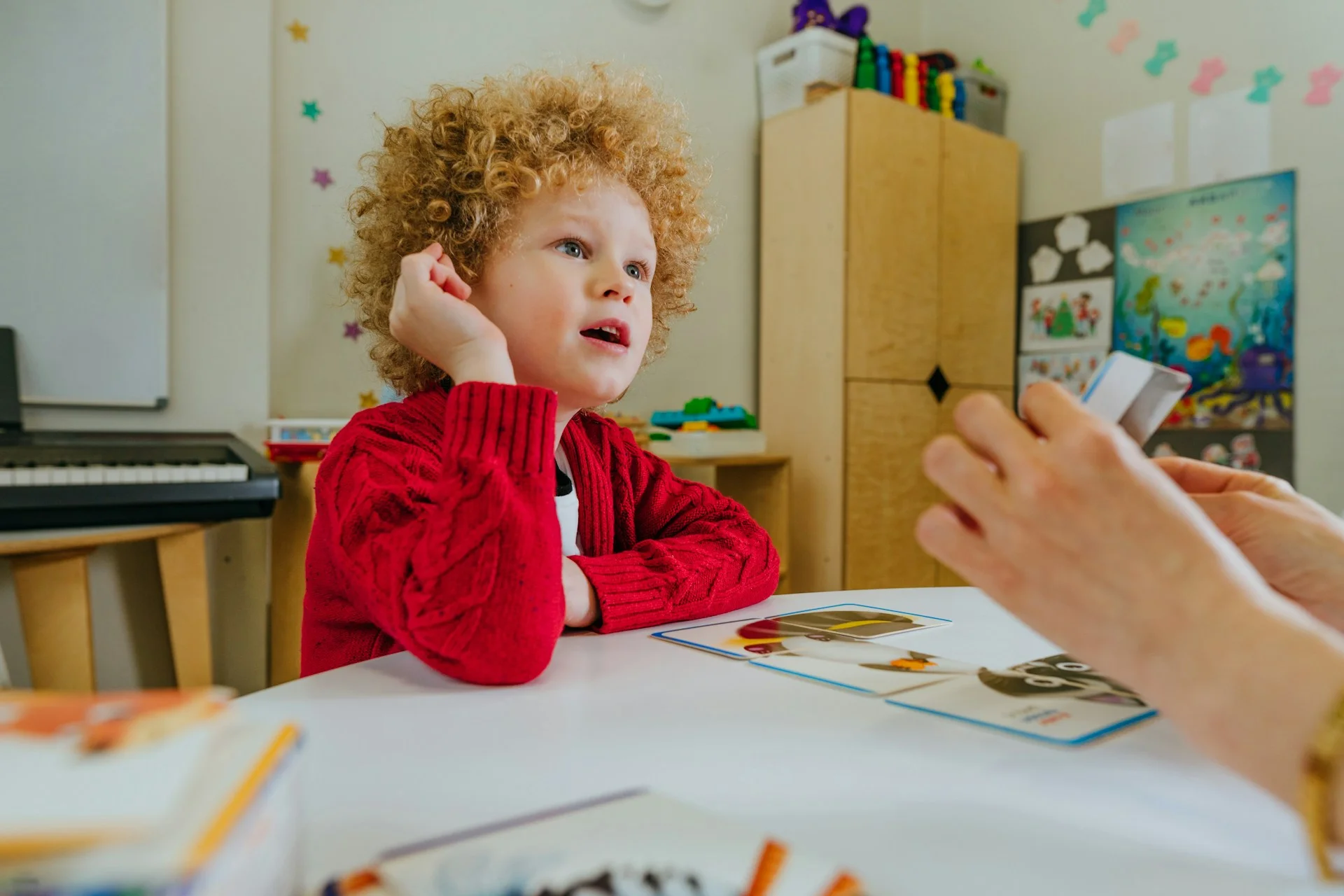 photo - a boy looking at his pru education teacher trying to understand something they're explaining in a pupil referral unit environment 