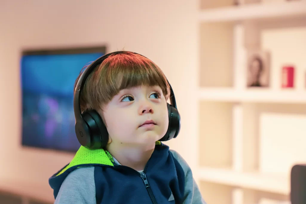 photo - a young boy studying with headphones on with the help of a EHC Plan Example Autism 