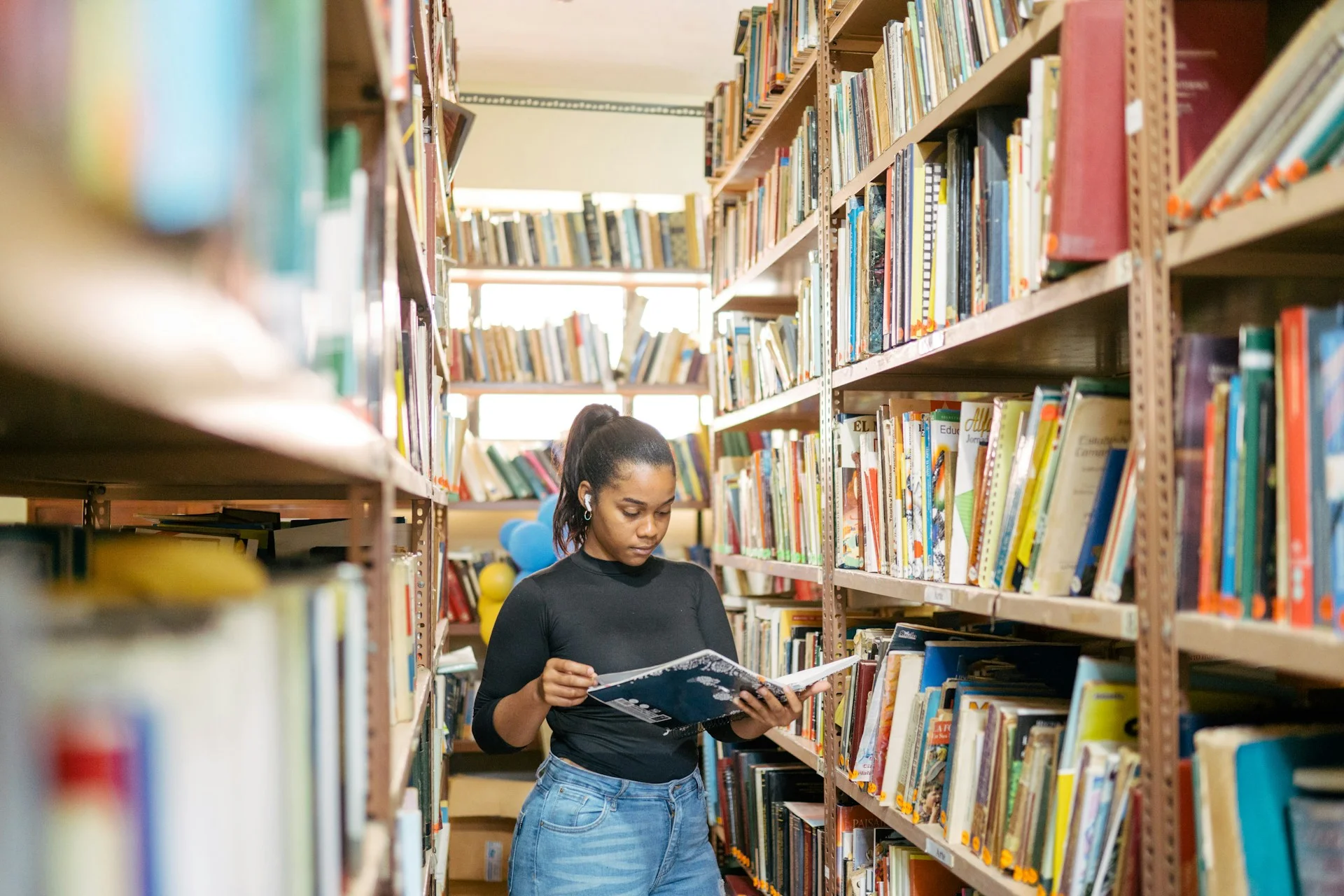 photo - a girl in a library preparing for post 16 education for special needs