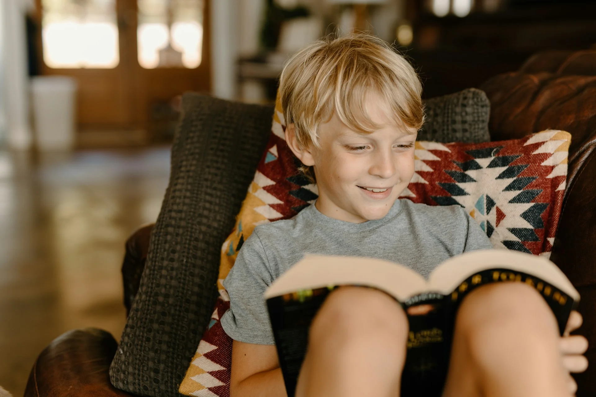 photo - a happy boy reading a book because he was switched  to alternative provisions 