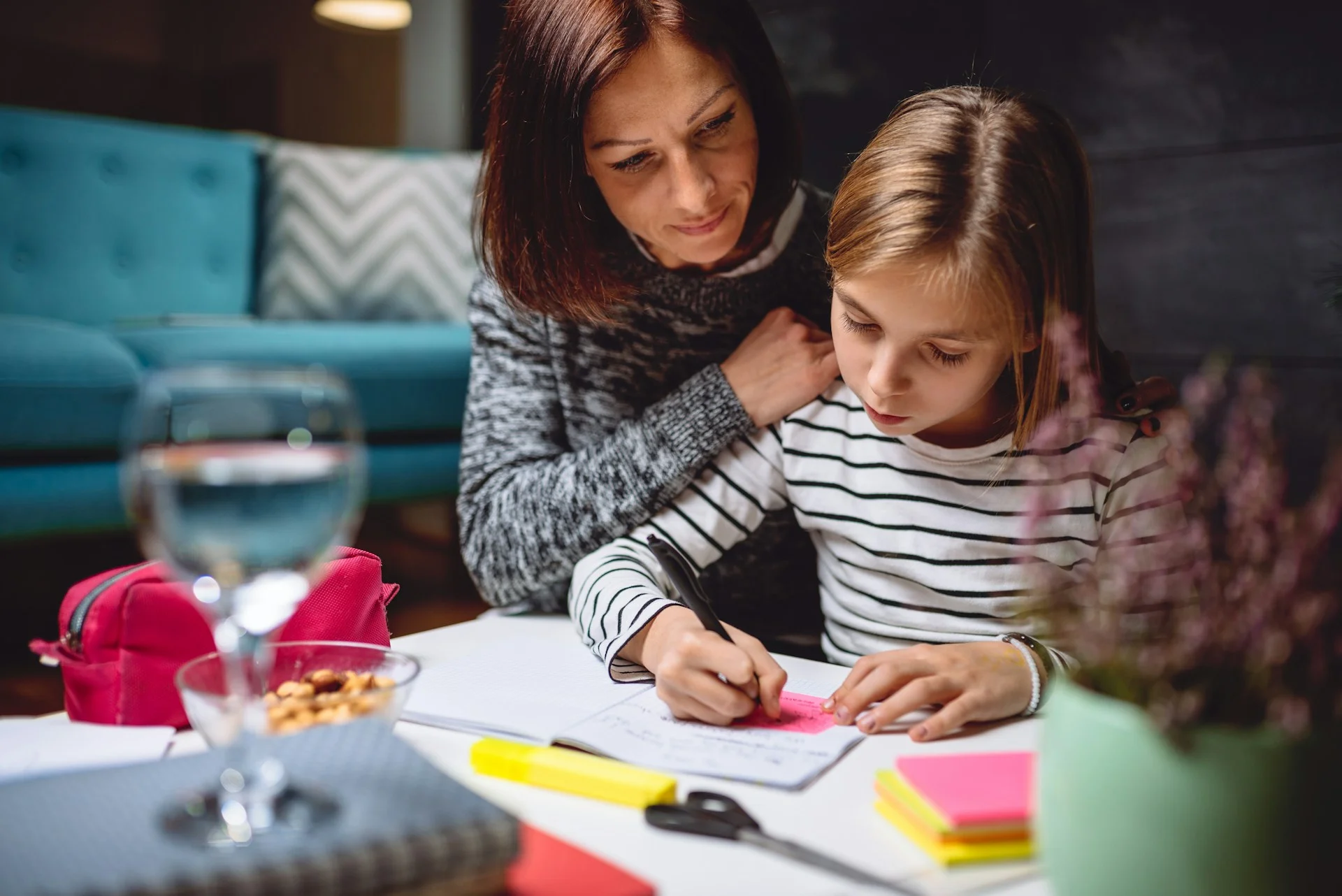 photo - a parent and daughter sitting together and doing homework in the living room covered under the ehcp hertfordshire