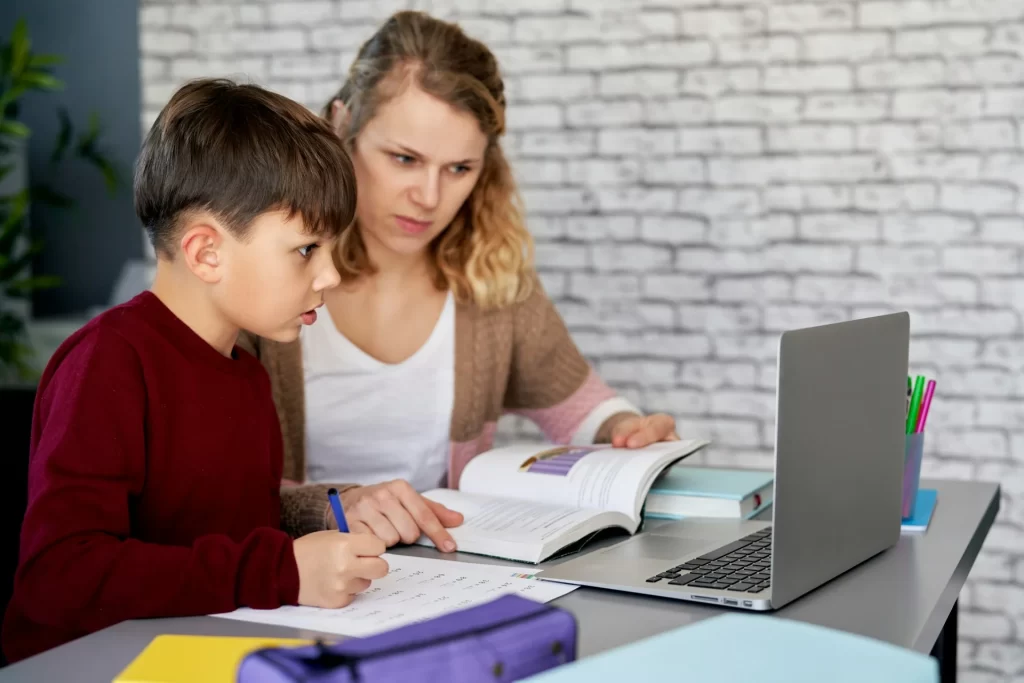 photo - a SEN tutor in Watford Hertfordshire helping a child with their homework from one of the schools in Watford Hertfordshire