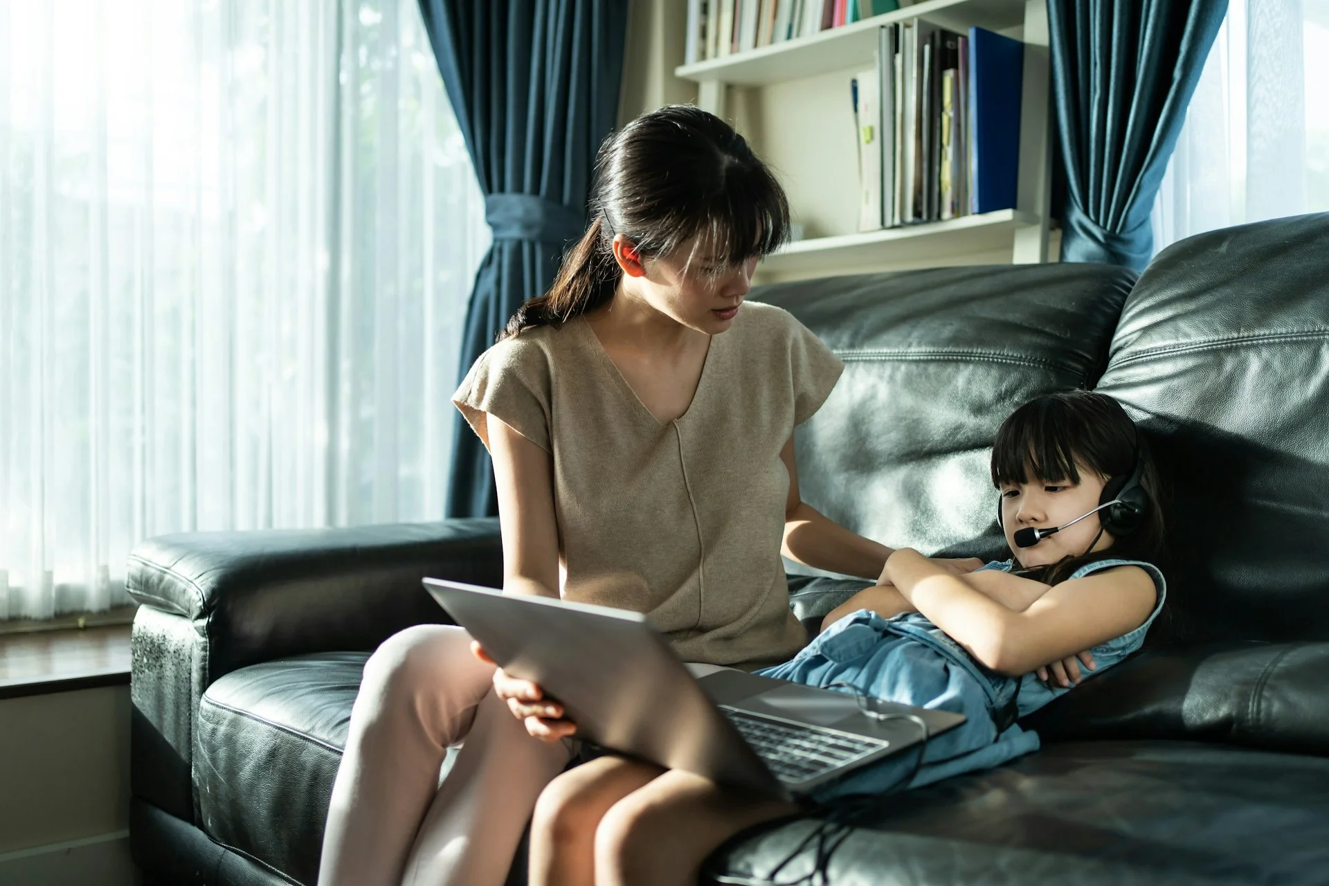 photo - a mother and her daughter sitting on the couch, the mother is worrying and wondering does my child need an ehcp