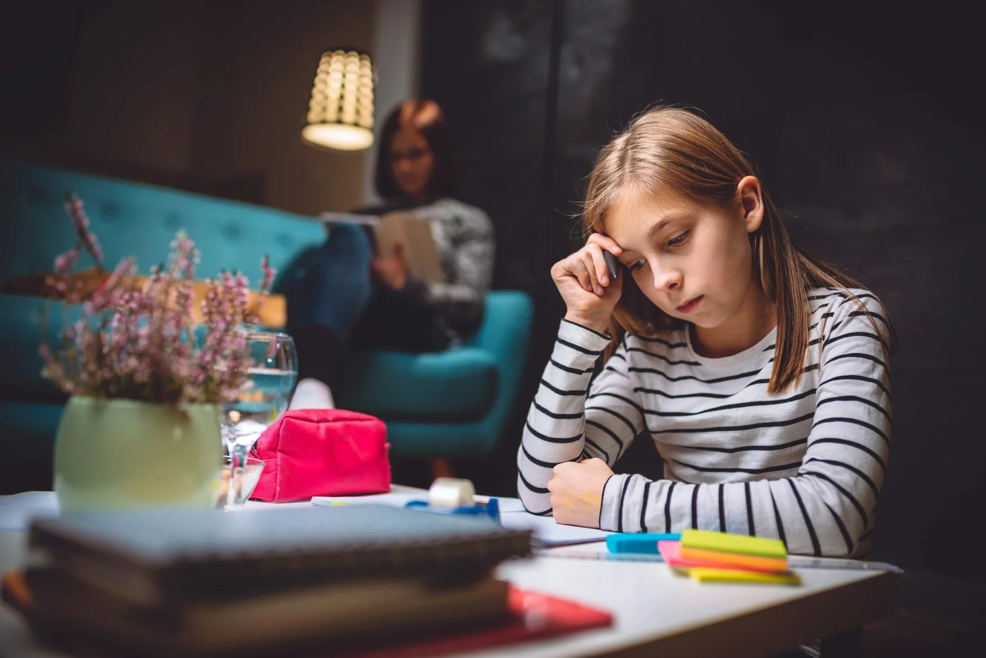 photo - a girl with dysparaxia struggling while writing homework in need of a dyspraxia assessment uk