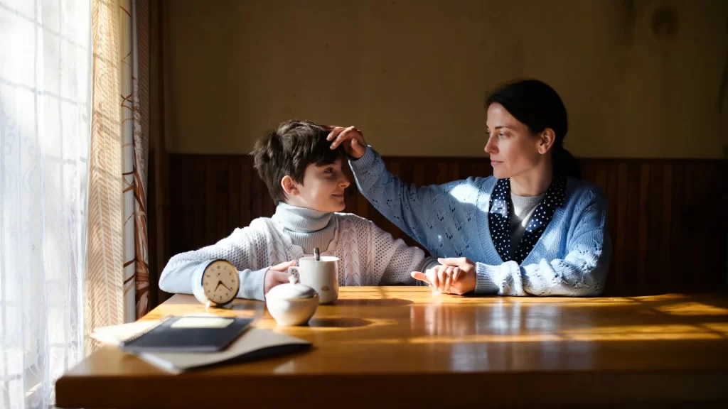 photo - a woman with a son covered under ehcp autism sitting at a kitchen table having breakfast