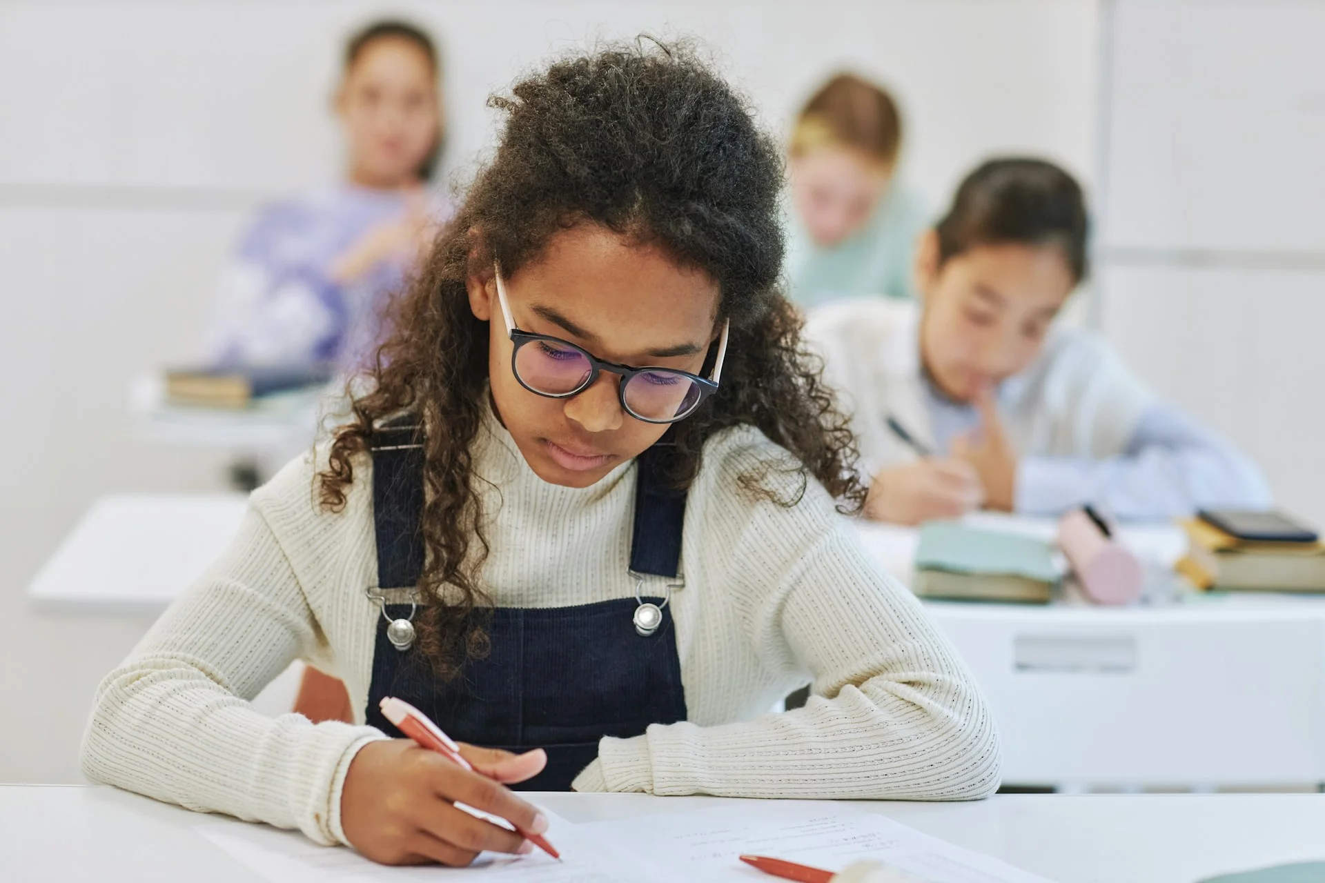 photo - a student at on e of the schools hemel hempstead governs looking at her sheet of paper in a classroom 