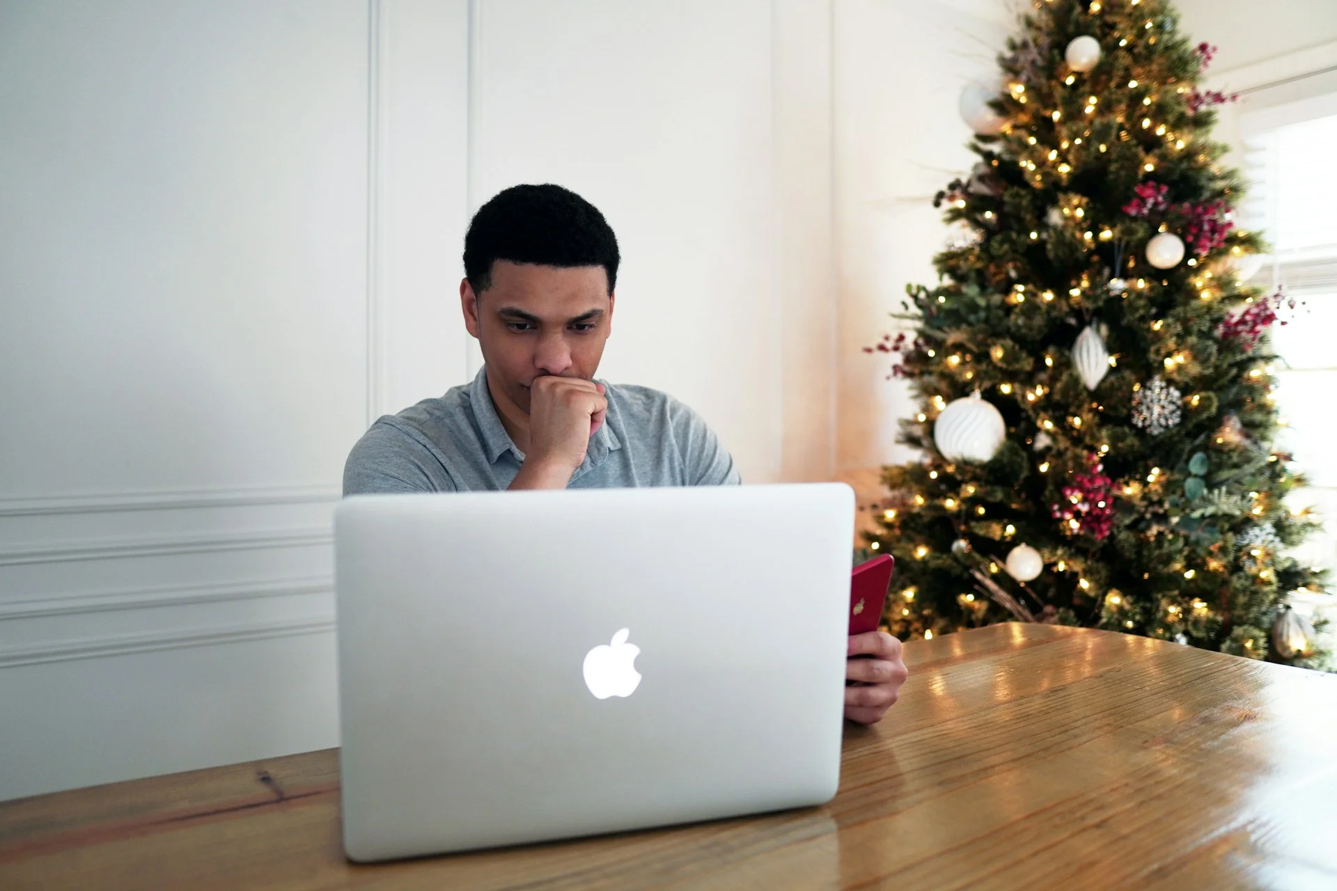 photo - a teenager is frowning at his computer in need of gcse tuition online session with SEN teachers