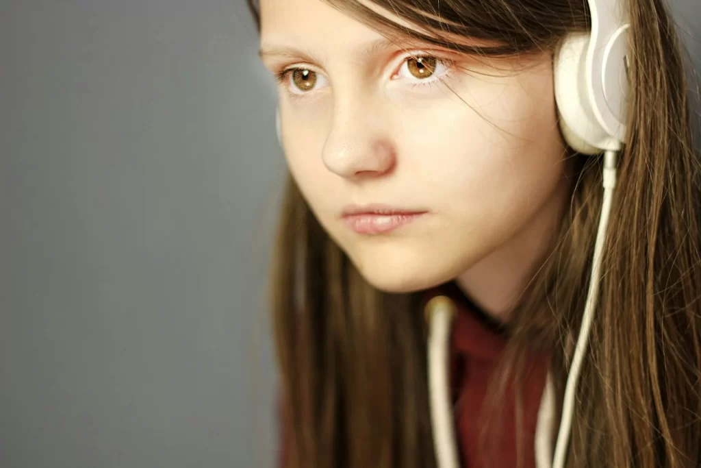 photo - a girl in headphones with dyslexia wondering about dyslexia rights in school uk