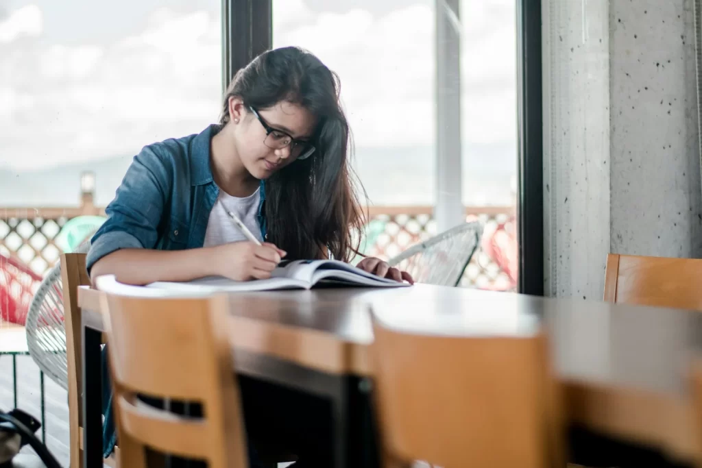 photo - an autistic girl sitting at a table studying for her Maths gcse tutor GCSE tuition session 