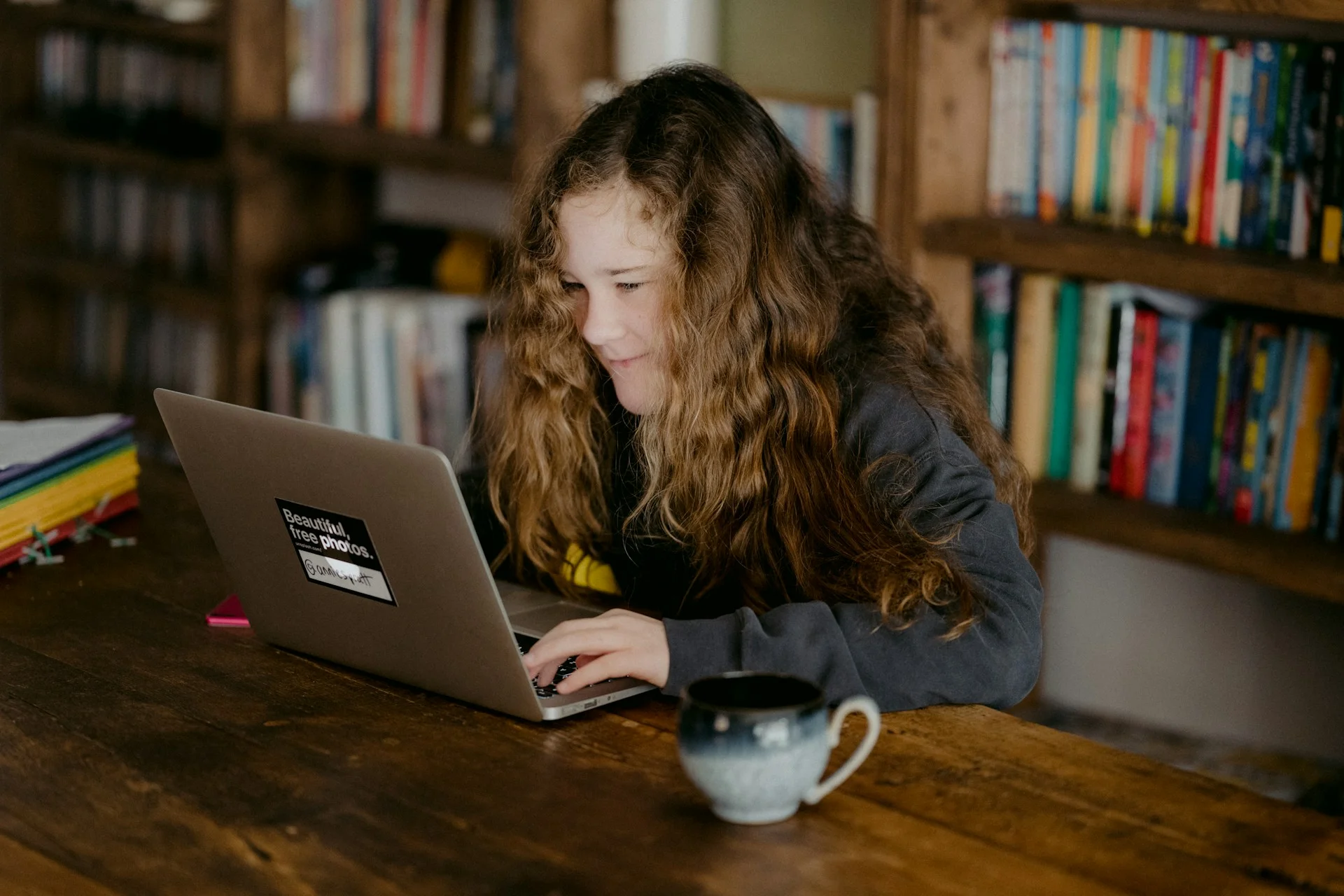 photo - a SEND student smiling at her teacher during their tuition online session 