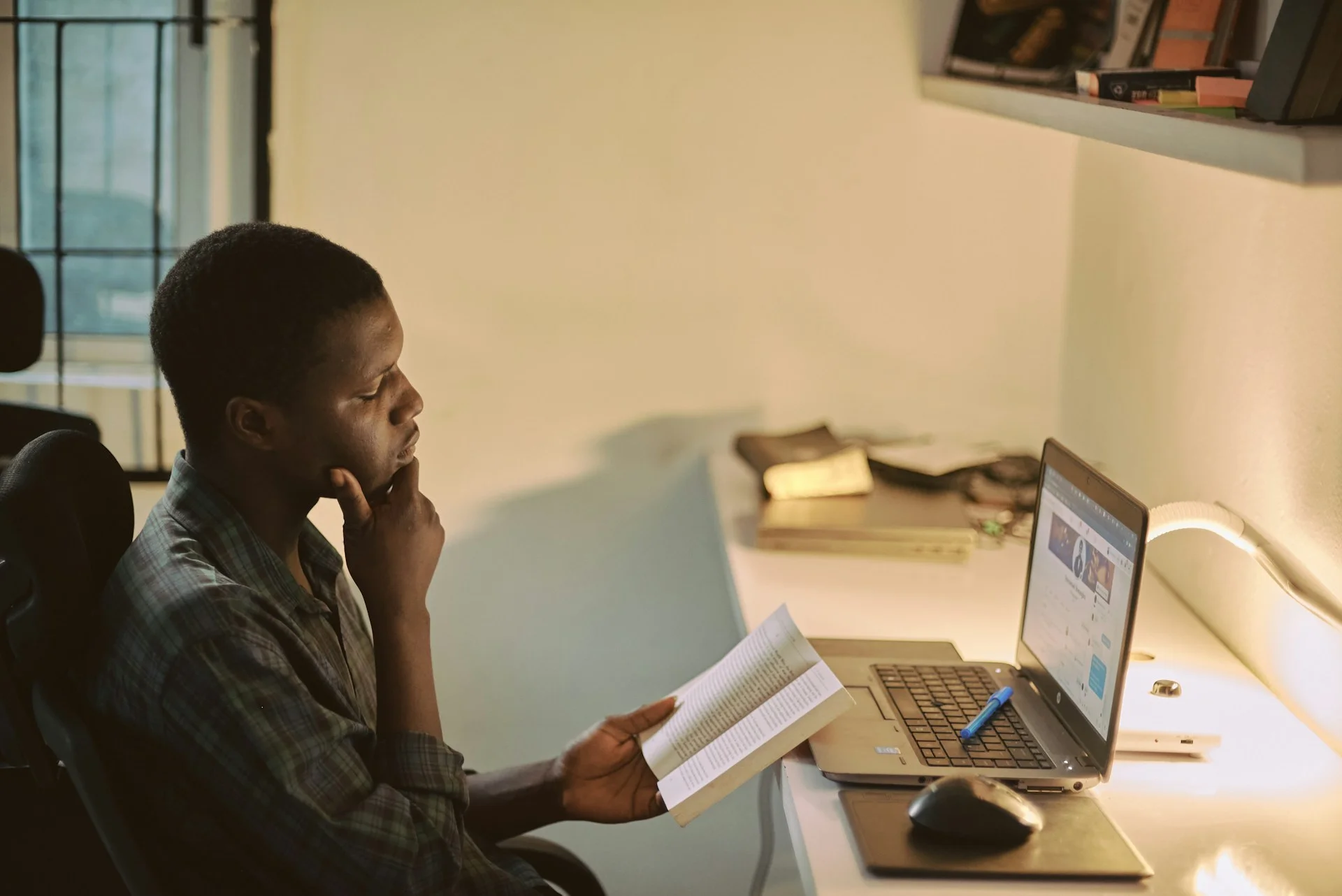 photo - a special educational needs student doing his homework in front of a computer in his bedroom