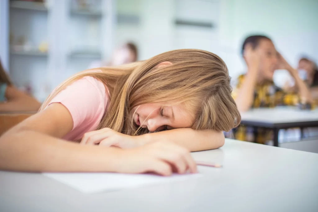 photo - a girl with moderate learning difficulties fell asleep in a classroom as she can't keep up in school without SEN tutoring help