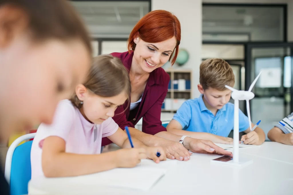 photo - a SEMH teacher tutoring three children