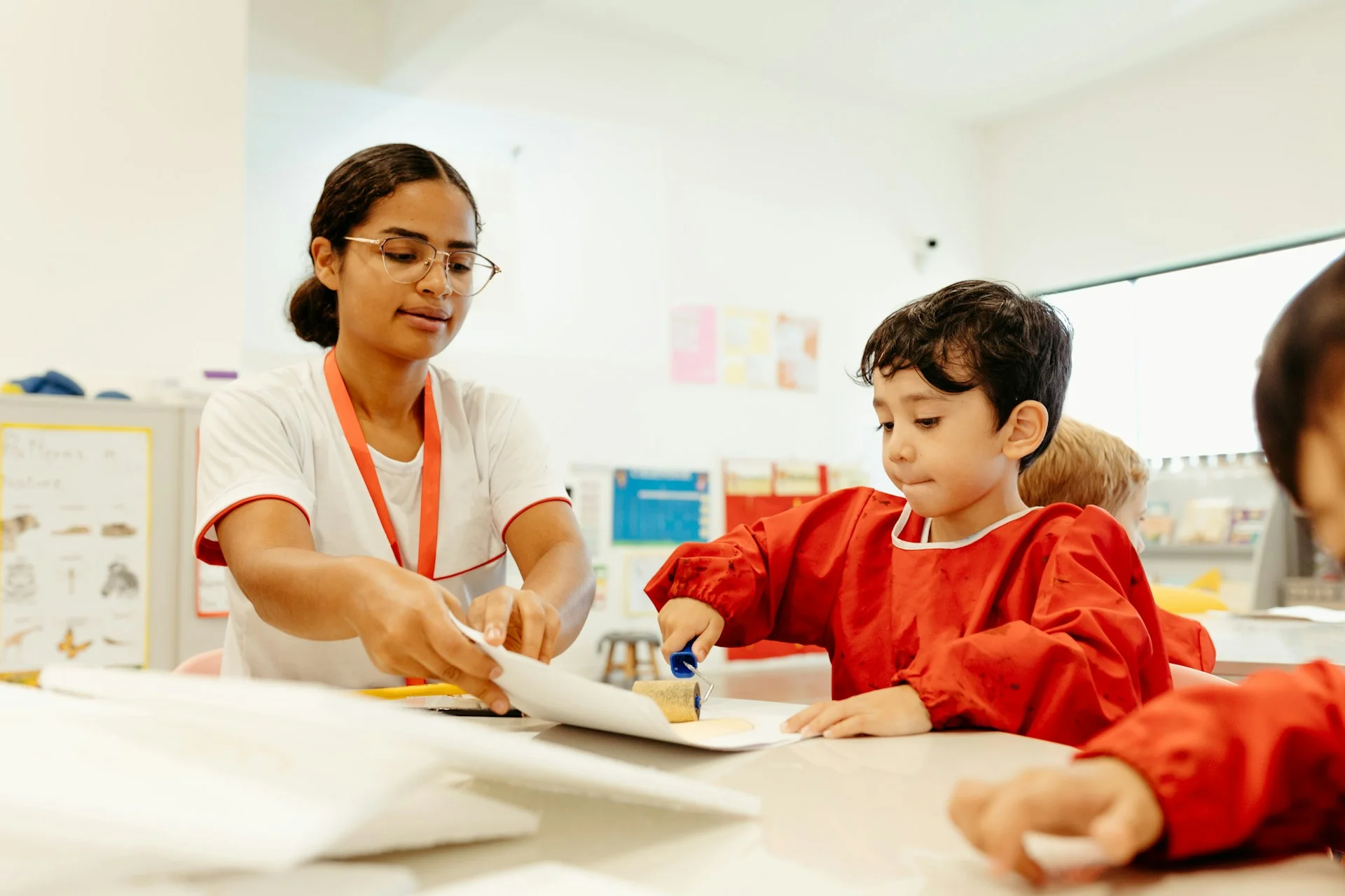 photo - a sen tutor is supporting an autistic child in a mainstream school