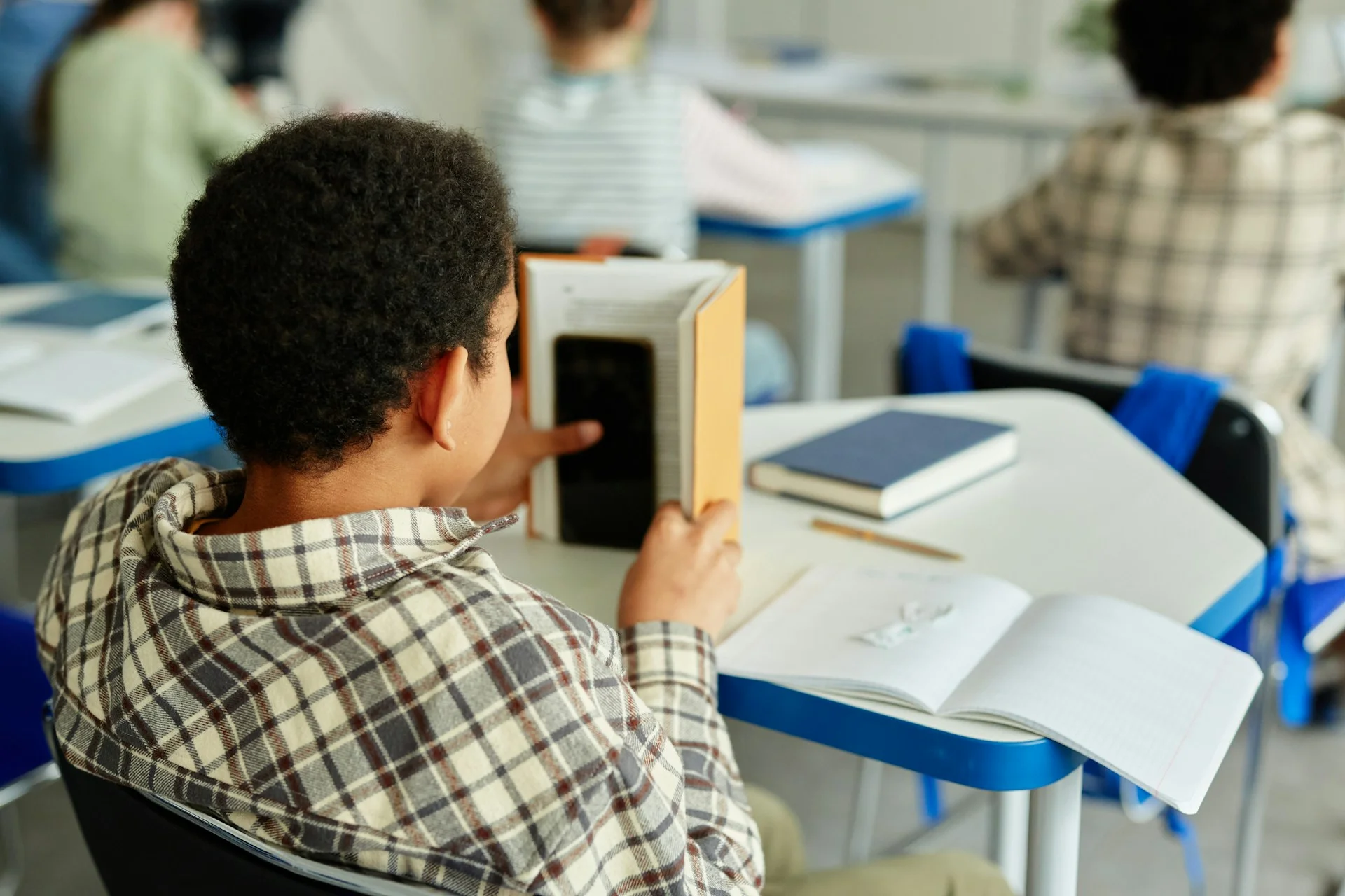 PHOTO - adhd support in schools uk a boy playing mobile games during class