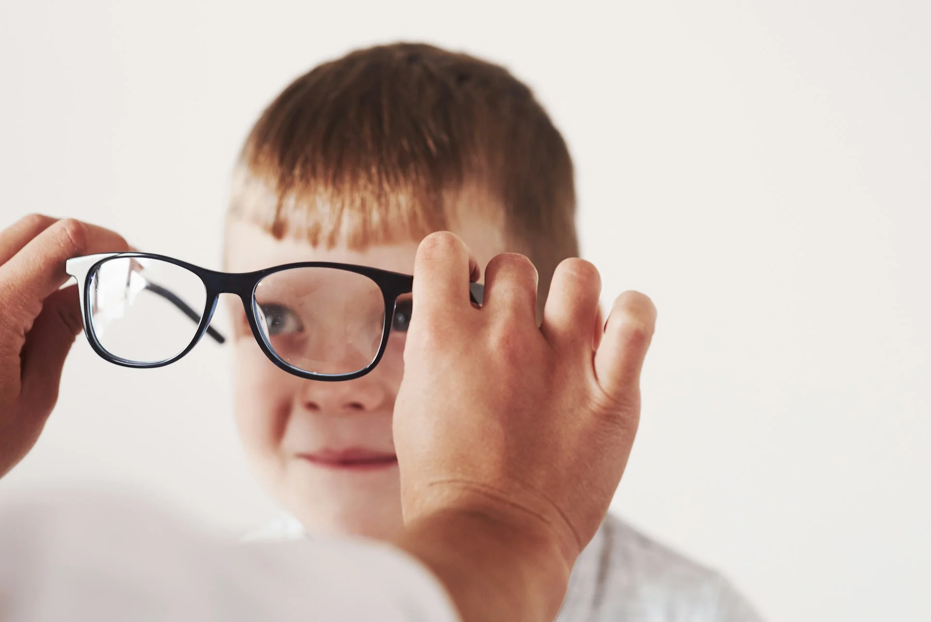 photo - a boy with glasses on at a doctor's office