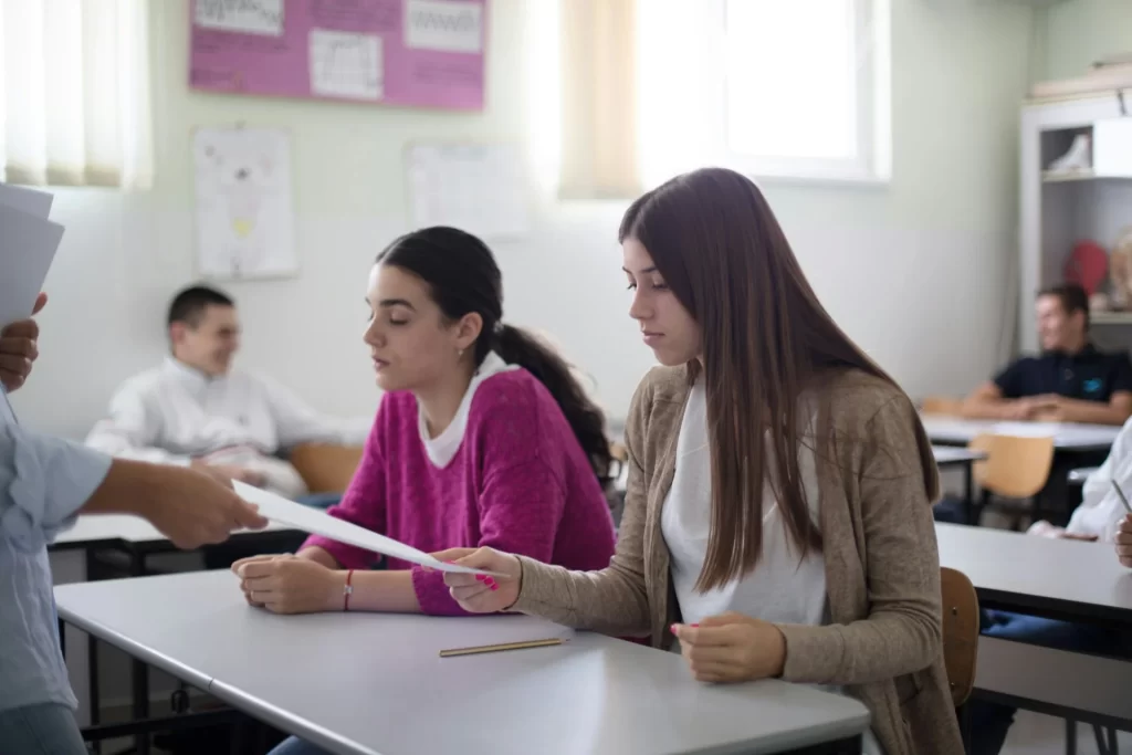 photo - two girls sitting in a classroom wondering "can you resit a levels"?