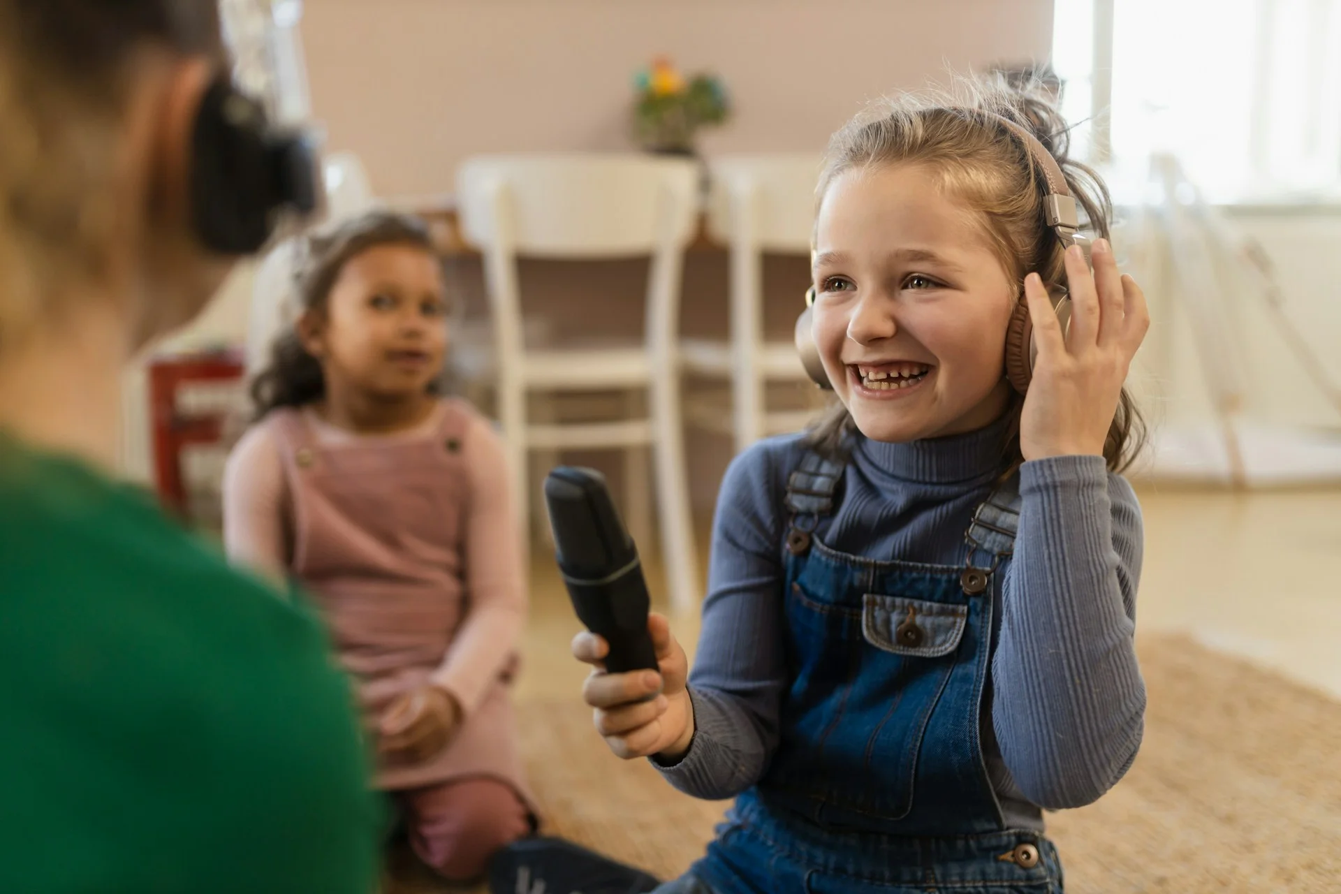 photo - a girl laughing in a classroom with speech and language communication needs