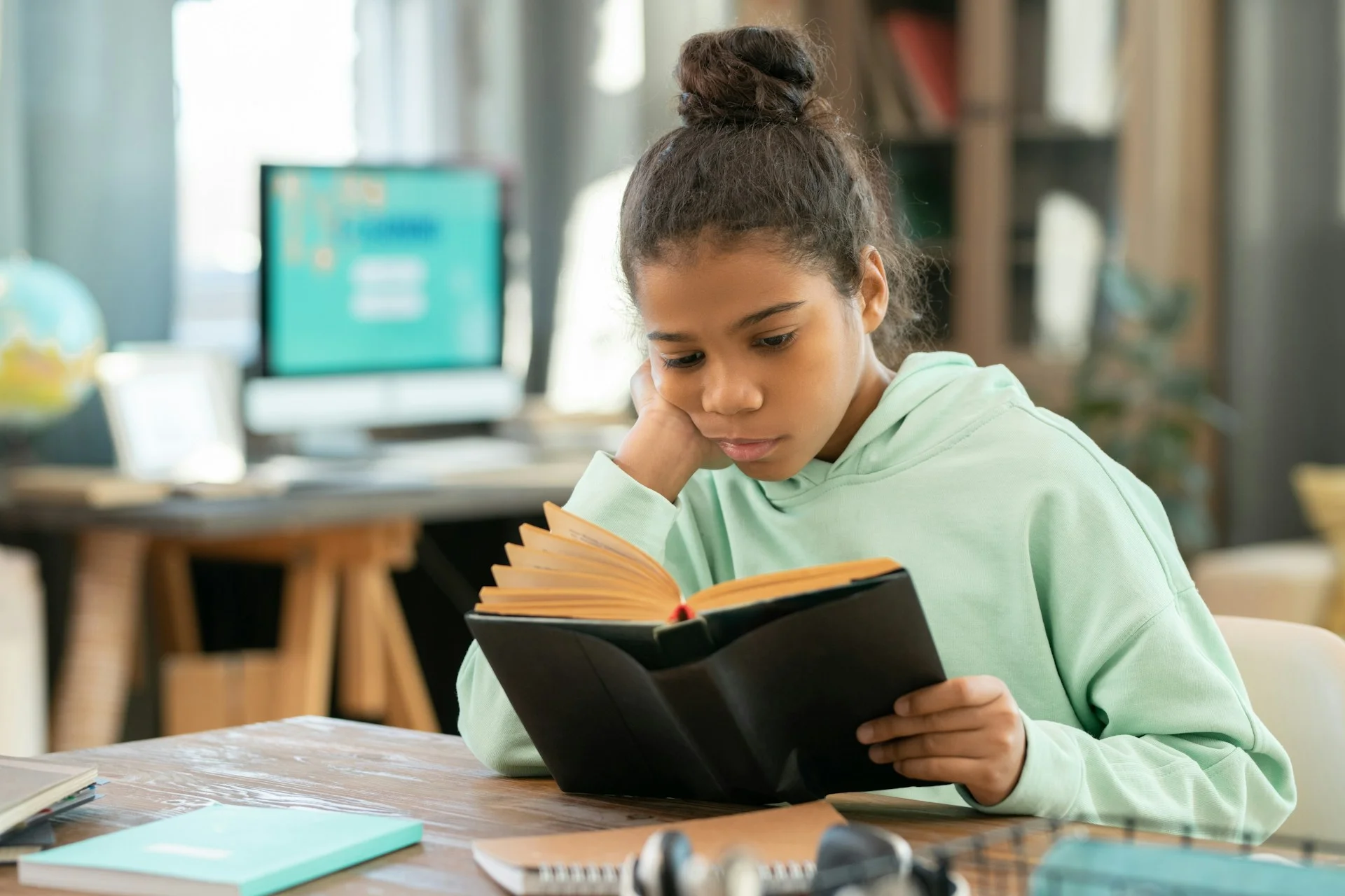 photo - a girl struggling to read a book at school in need of adhd support in schools uk