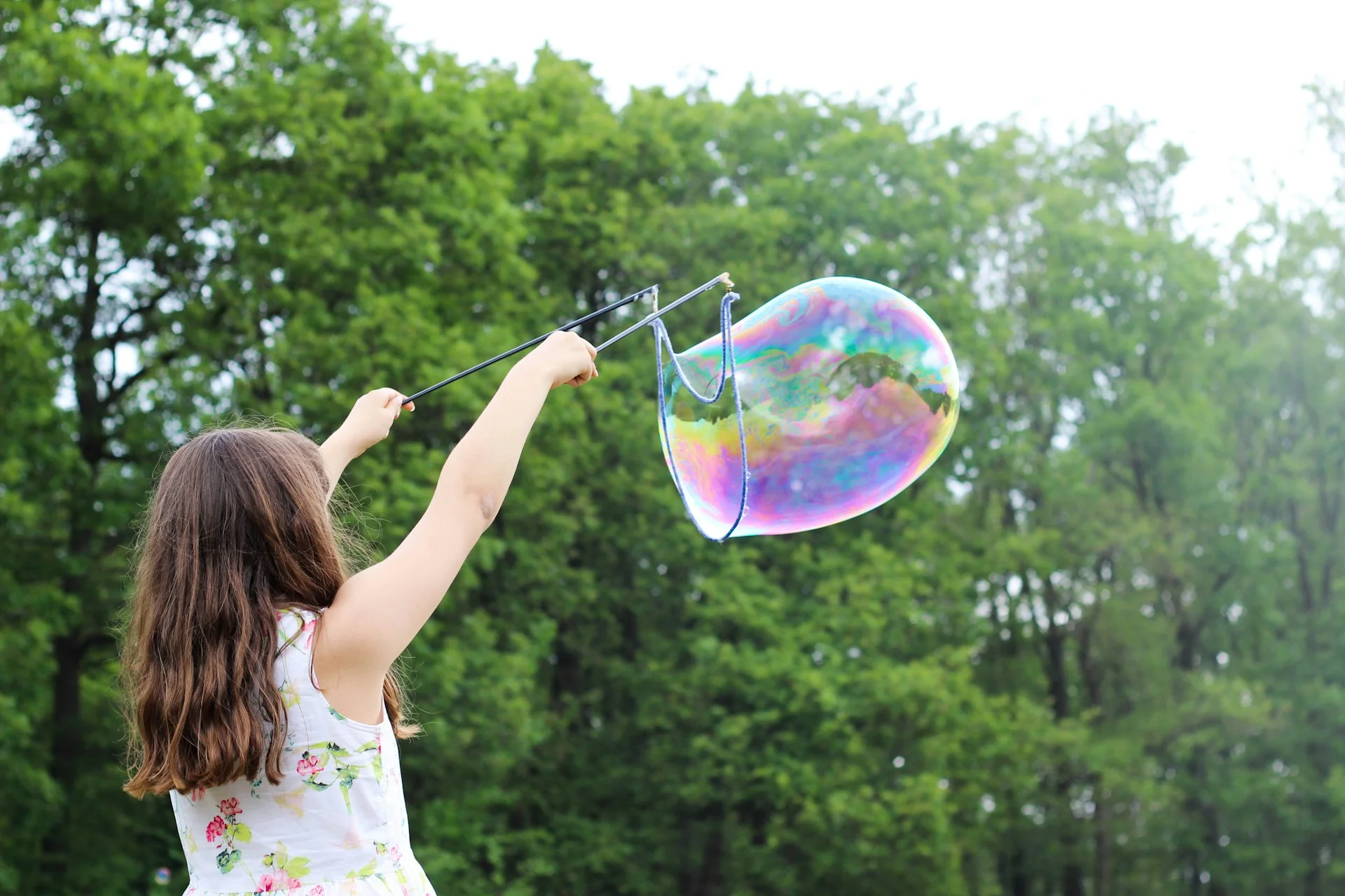 photo - a girl playing around with bubbles outside send legislation