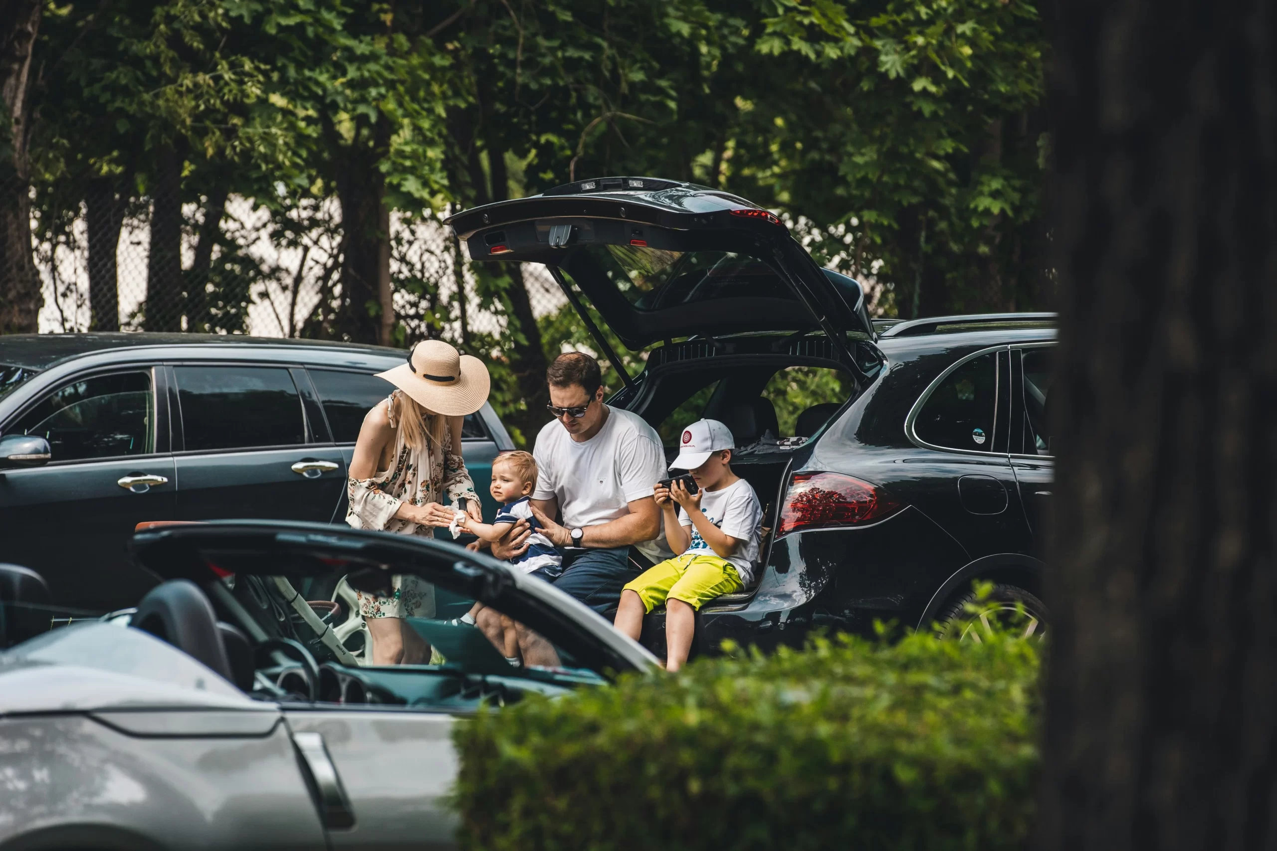 photo - Family sitting in a car outside during one of their Cheap family days out London in a park