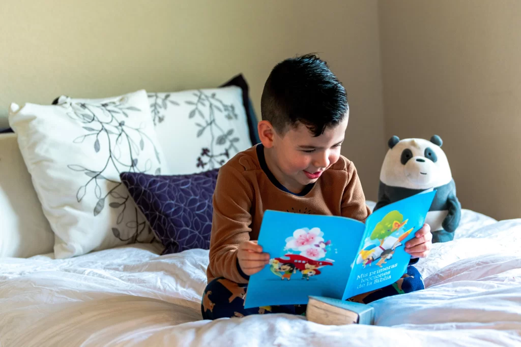 Photo - A boy reading on his bed participates in SEN activities with special educational needs resources.