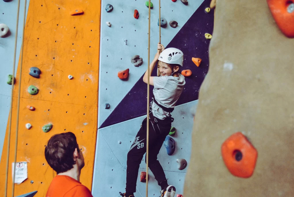 Photo - A girl rock climbing demonstrates SEN activities for learning disabilities with SEN resources.