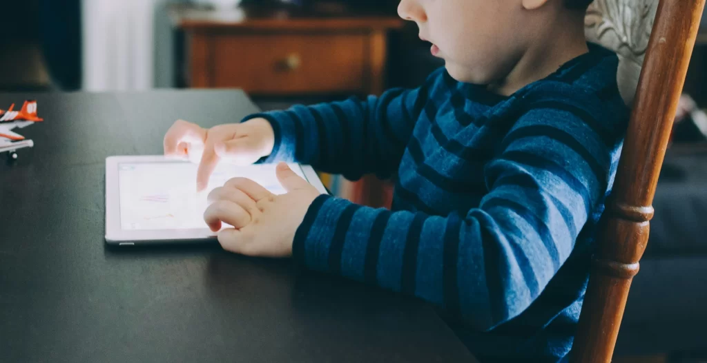 Photo - Boy using iPad for dyslexia and irlens.