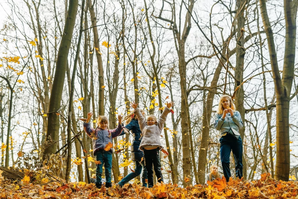 Photo - Kids playing in leaves portraying educational activities for special needs students. 