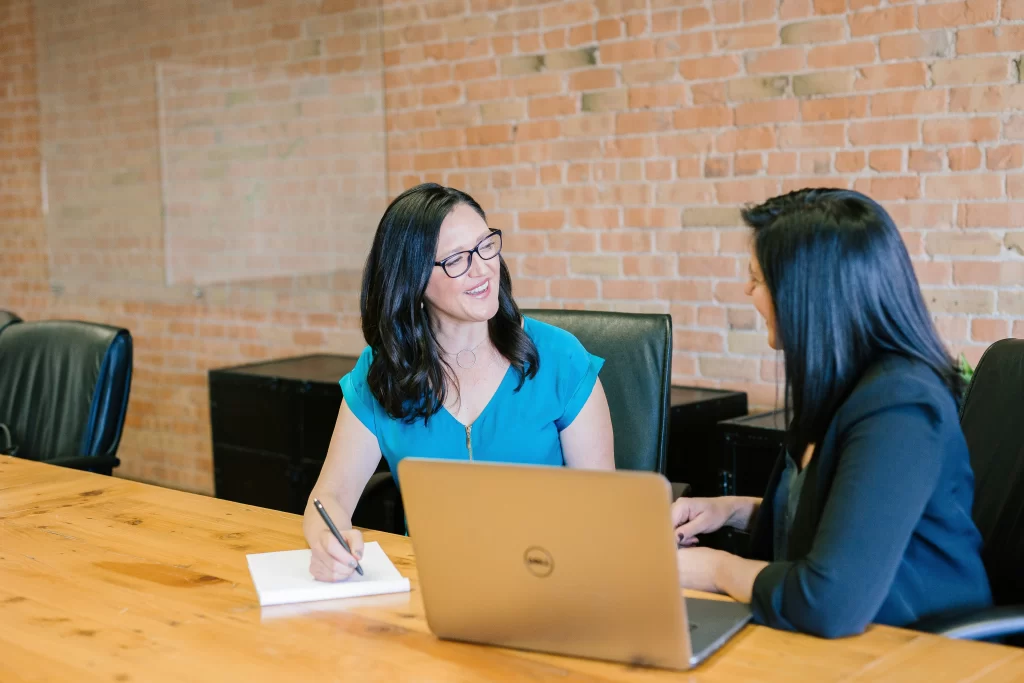 Photo - Two women engaged in a meeting learning how to win a SEN tribunal and preparing for a case review form SEND tribunal. 