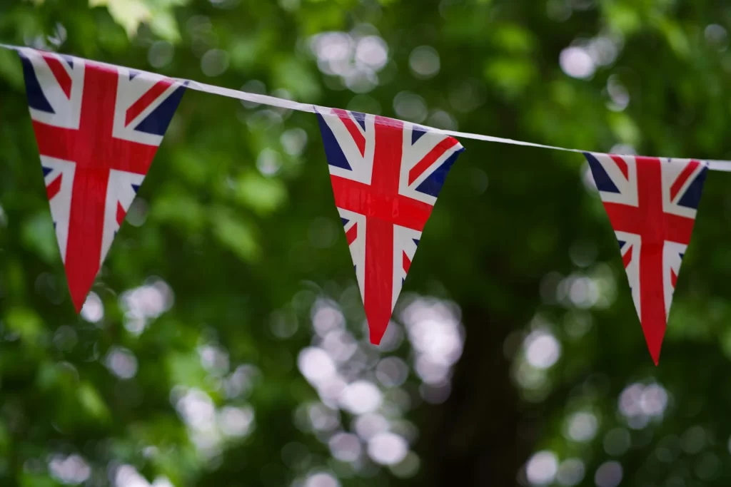 photo - british flags hanging in a park near schools in borehamwood