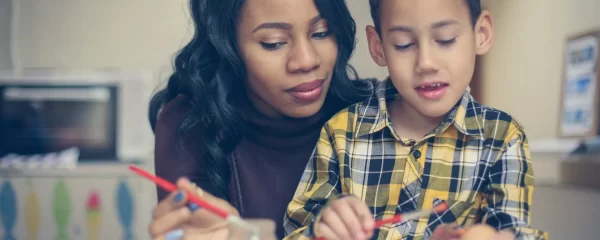 photo - a sen tutor doing homework with a boy on sen plan