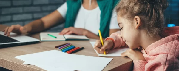 photo - a girl and a her SEN tutor working on the girl's dyspraxia and handwriting