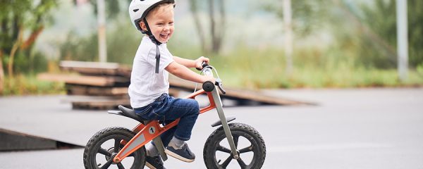 kid riding his bike and smiling